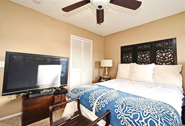 carpeted bedroom featuring a closet and ceiling fan