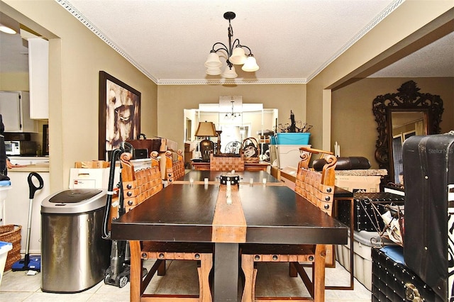 dining space featuring crown molding, light tile patterned floors, a textured ceiling, and a chandelier