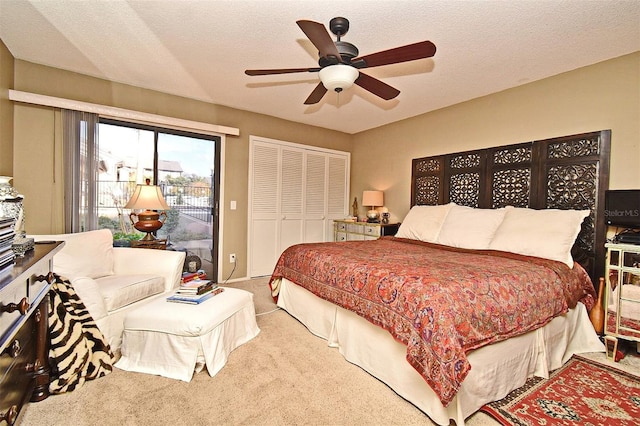 bedroom with access to exterior, carpet, a textured ceiling, and ceiling fan