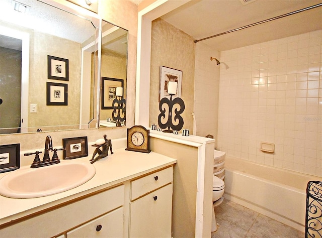 full bathroom with tiled shower / bath combo, vanity, tile patterned floors, and toilet