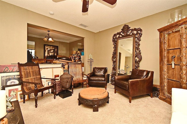 living area featuring crown molding, carpet floors, and ceiling fan