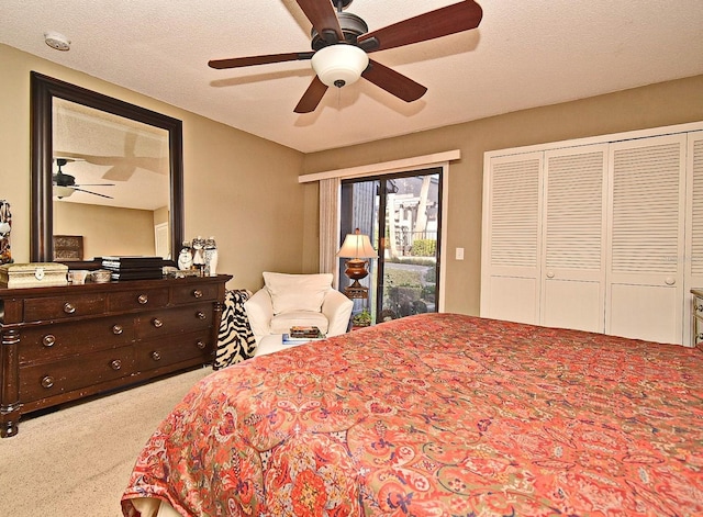 bedroom with ceiling fan, light colored carpet, access to exterior, and a textured ceiling