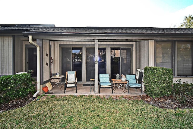 back of property featuring a patio and a yard