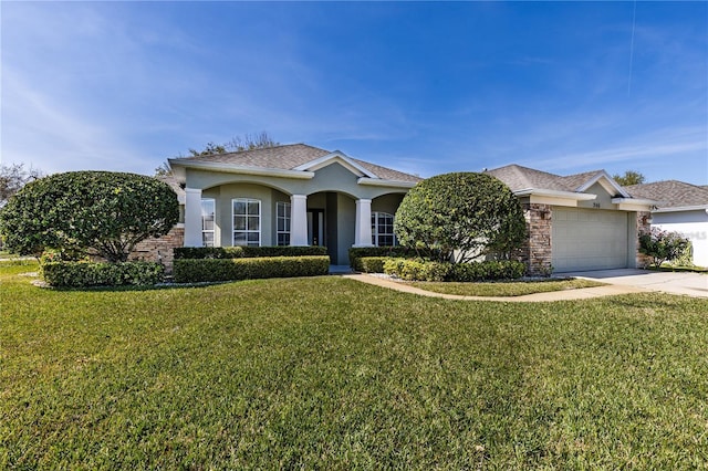 view of front of home featuring a garage and a front lawn