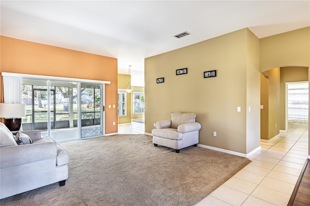 living room with light tile patterned floors and a healthy amount of sunlight