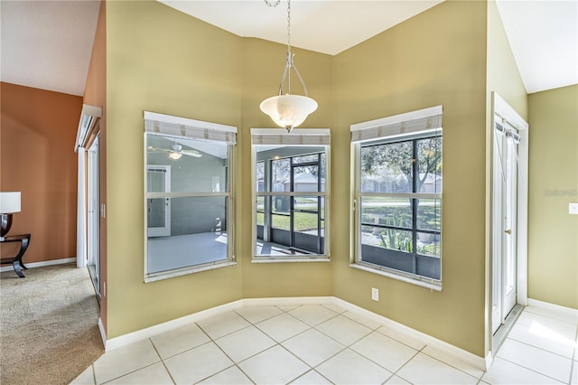 tiled dining room featuring ceiling fan and lofted ceiling