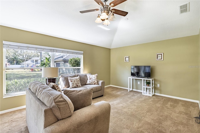 carpeted living room with ceiling fan, lofted ceiling, and a wealth of natural light