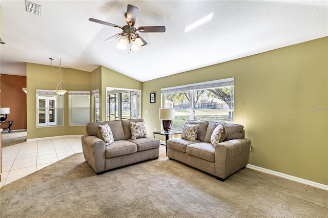 tiled living room with ceiling fan and lofted ceiling