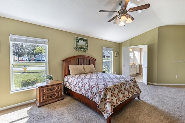 carpeted bedroom with ensuite bath, ceiling fan, and lofted ceiling