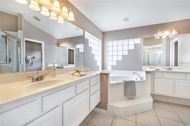 bathroom with tile patterned flooring, vanity, and plus walk in shower