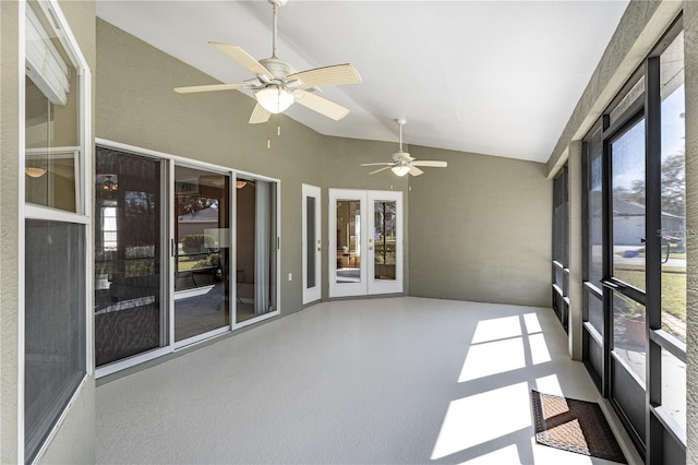 unfurnished sunroom featuring a wealth of natural light, french doors, ceiling fan, and vaulted ceiling