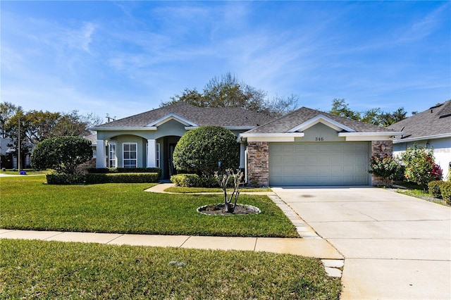 ranch-style house featuring a garage and a front lawn