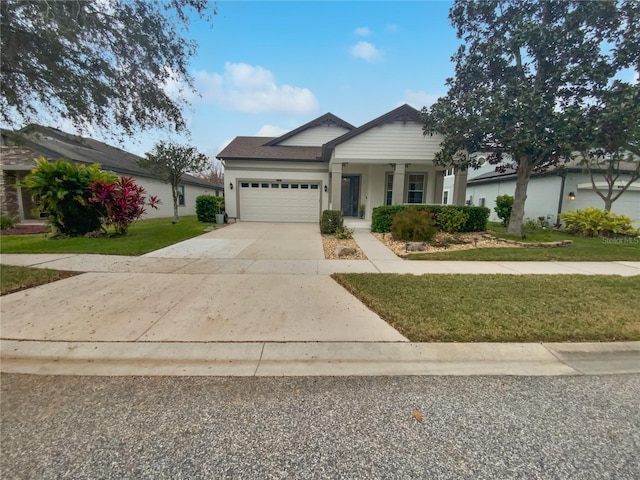 view of front of home with a front yard and a garage