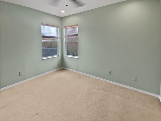 carpeted empty room featuring ceiling fan