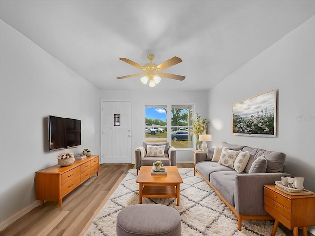 living room with light wood-type flooring and ceiling fan