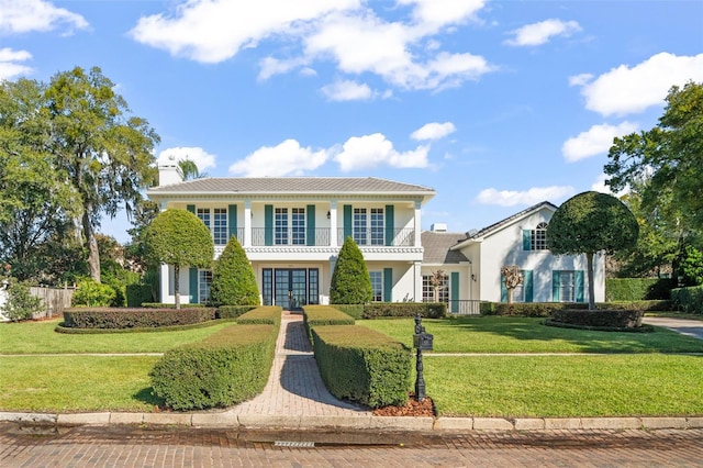 view of front of house with french doors and a front lawn