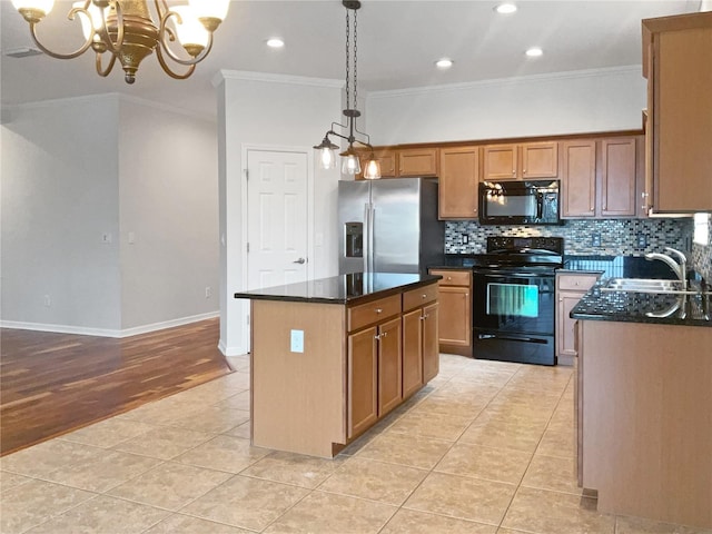 kitchen featuring sink, a center island, an inviting chandelier, ornamental molding, and black appliances