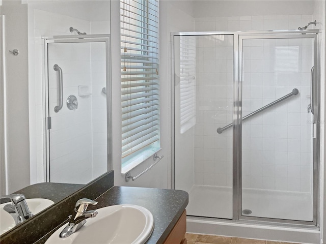 bathroom with vanity, an enclosed shower, and tile patterned flooring