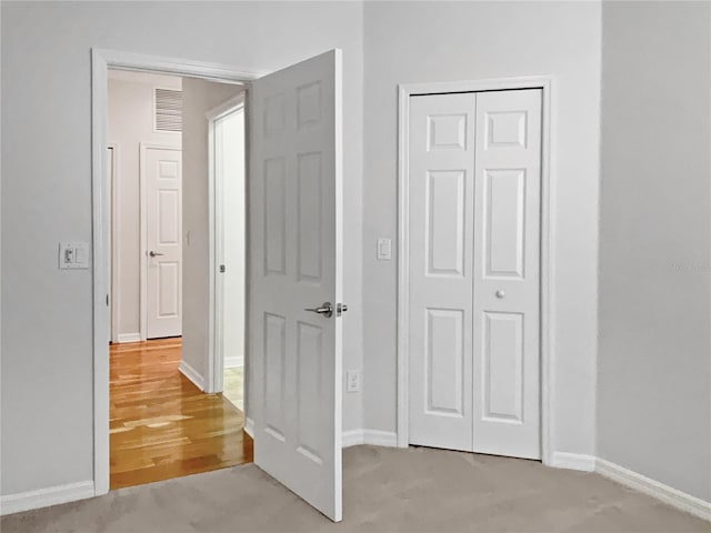 hallway featuring light carpet