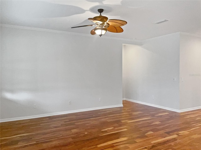 spare room featuring ceiling fan, crown molding, and dark hardwood / wood-style flooring