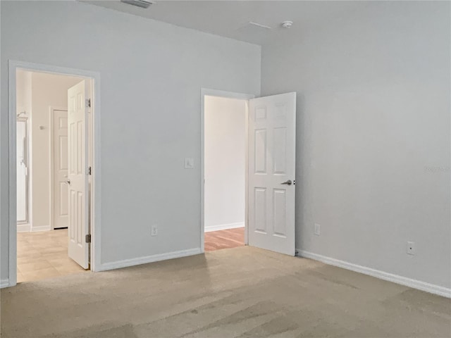 spare room with light carpet