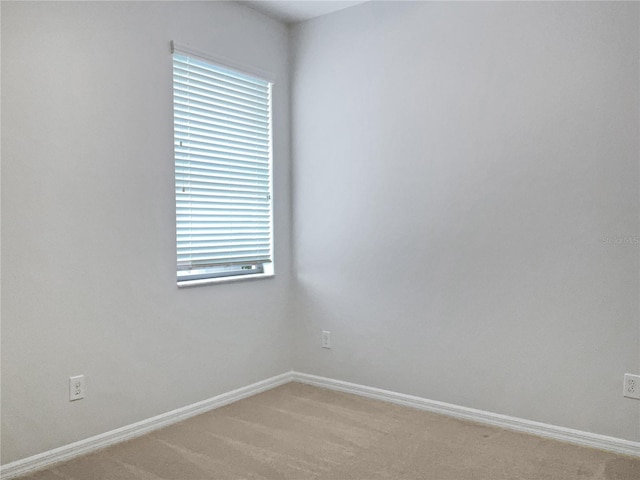 unfurnished room featuring light carpet