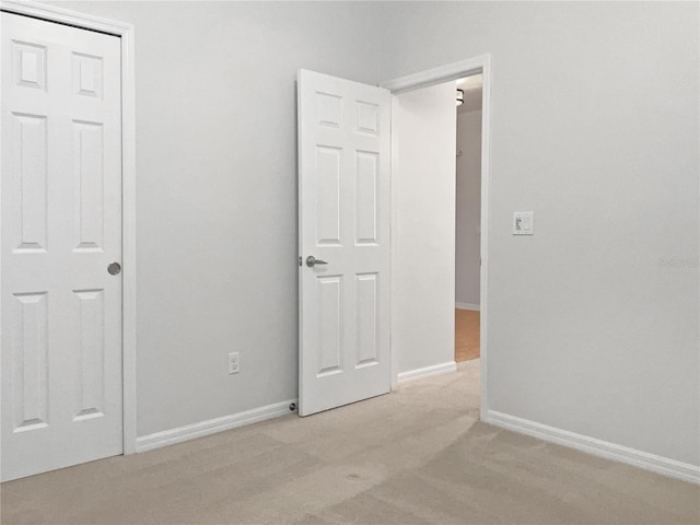 unfurnished bedroom with light colored carpet