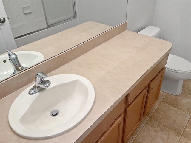 bathroom with vanity, tile patterned floors, and toilet