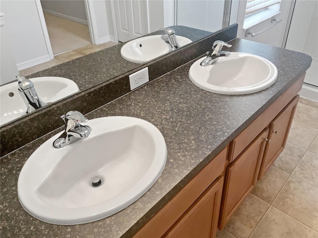 bathroom with tile patterned floors and vanity