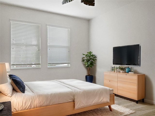 bedroom with light carpet and ceiling fan