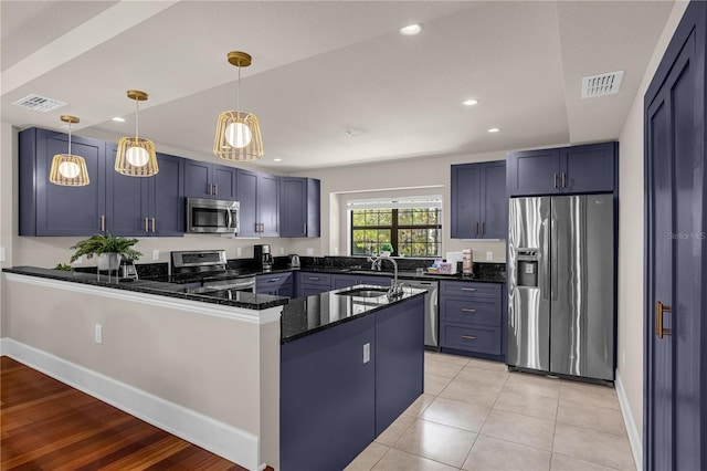 kitchen with stainless steel appliances, blue cabinets, kitchen peninsula, decorative light fixtures, and light tile patterned floors