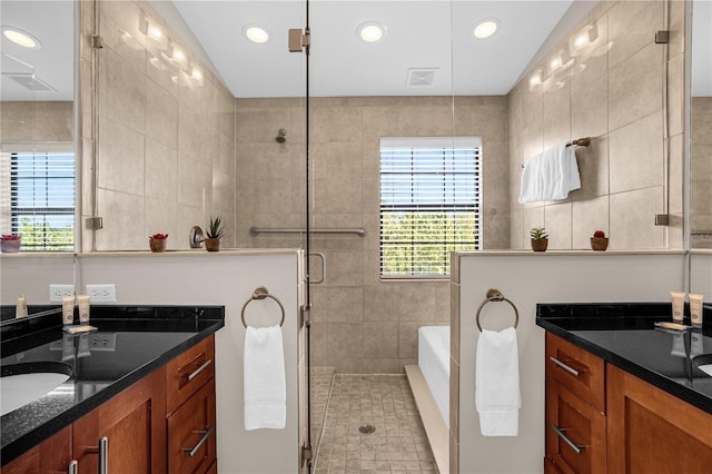 bathroom with vanity, separate shower and tub, and tile walls