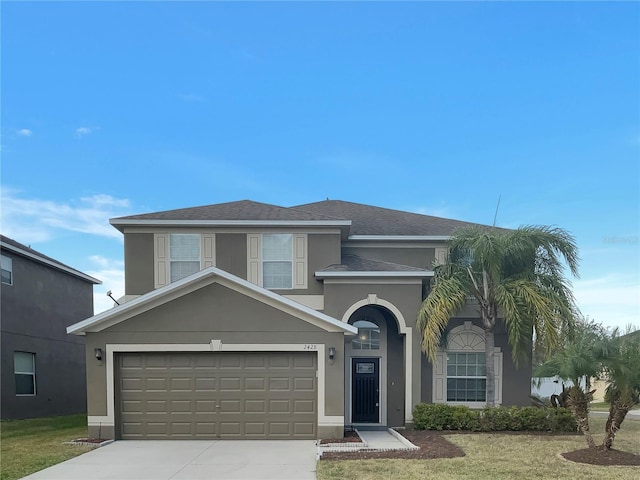 view of front facade featuring a front yard and a garage