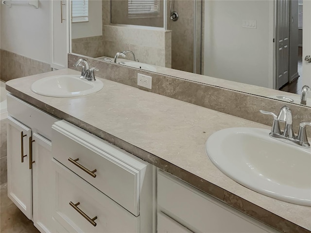 bathroom featuring an enclosed shower and vanity