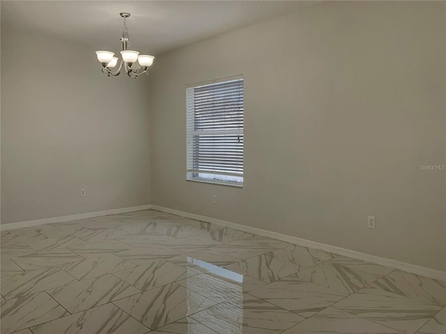 unfurnished room featuring a notable chandelier