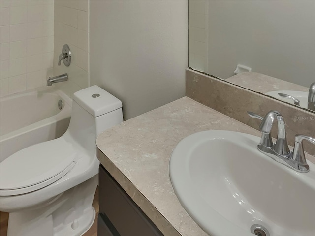 full bathroom with toilet, vanity, and washtub / shower combination