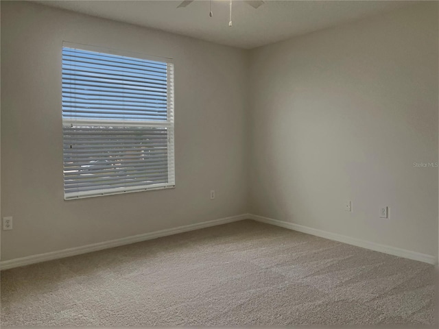 unfurnished room with carpet flooring and ceiling fan