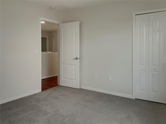 unfurnished bedroom featuring carpet floors and a closet