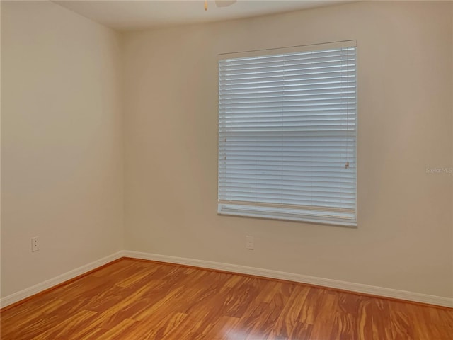 empty room featuring ceiling fan and light hardwood / wood-style flooring