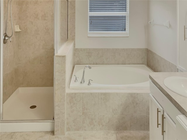 bathroom featuring shower with separate bathtub and vanity