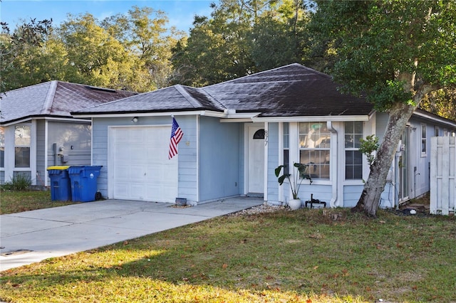 ranch-style house featuring a garage and a front yard