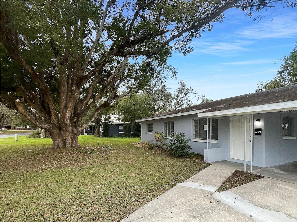 view of property exterior featuring a lawn