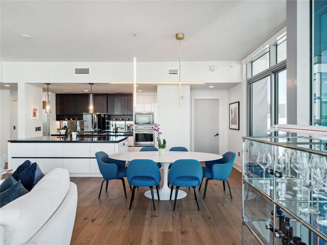 dining space featuring wood-type flooring