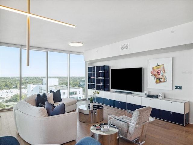 living room with expansive windows and hardwood / wood-style floors