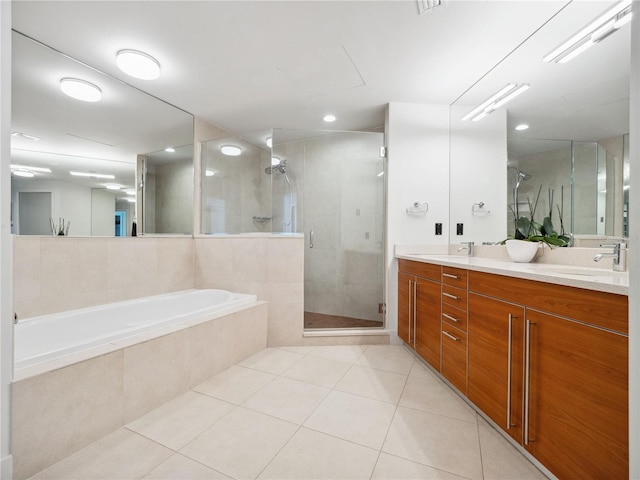 bathroom with tile patterned flooring, vanity, and separate shower and tub