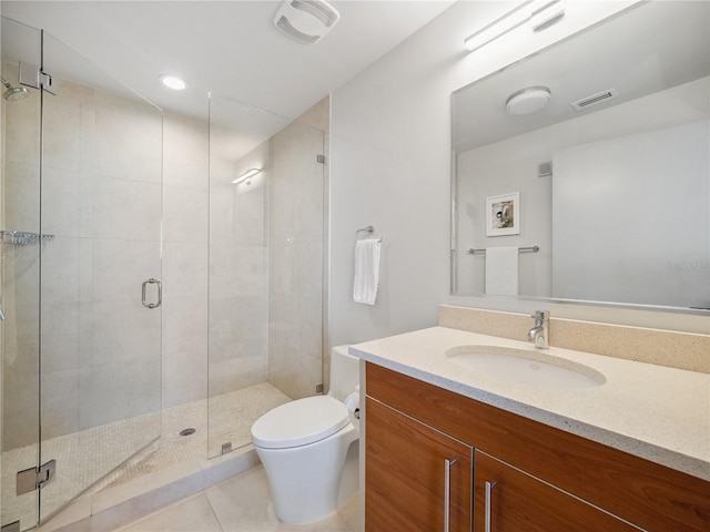 bathroom featuring tile patterned flooring, vanity, walk in shower, and toilet