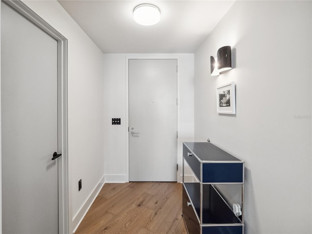 doorway with hardwood / wood-style flooring