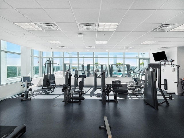 exercise room with a paneled ceiling