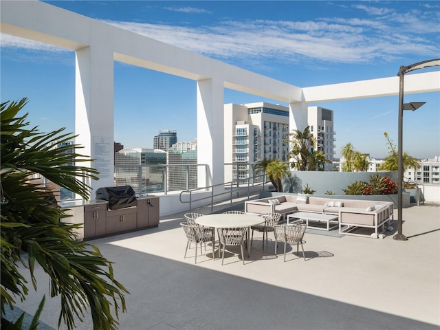 view of patio / terrace with an outdoor living space, exterior kitchen, and area for grilling