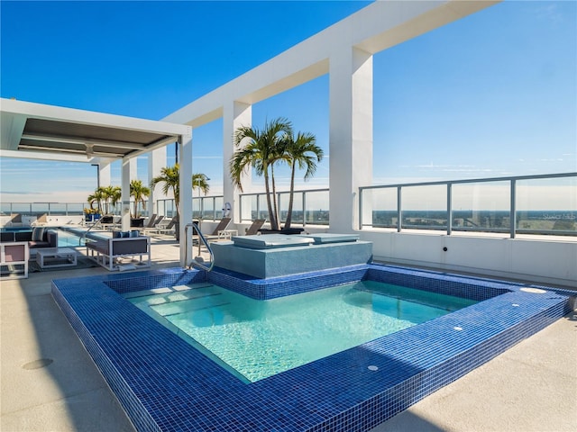 view of swimming pool with a hot tub and a patio